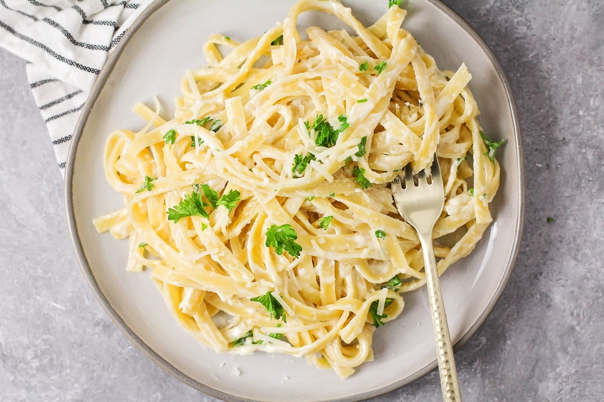 Easy Fettuccine Alfredo served on a white plate.