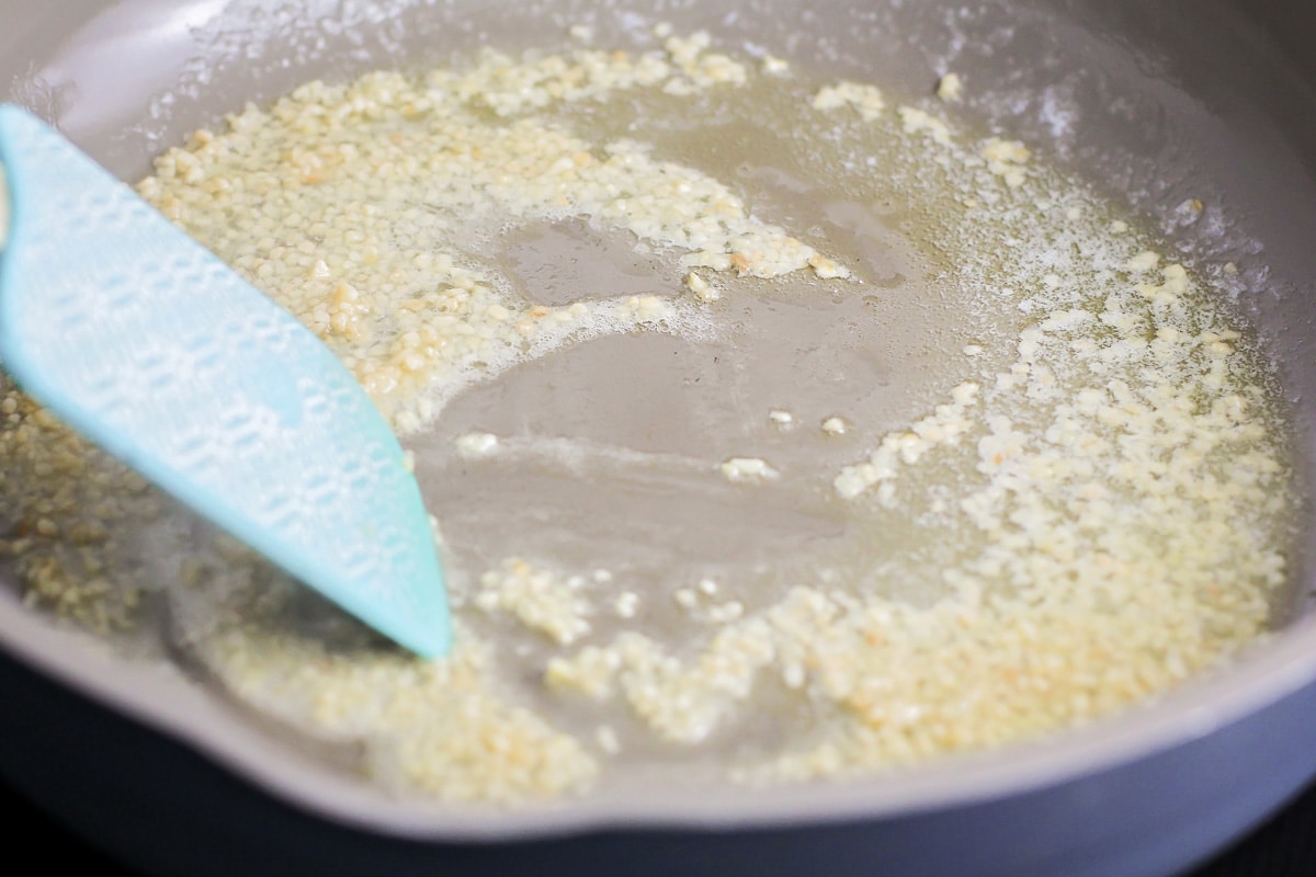 Minced garlic cooking in large skillet.