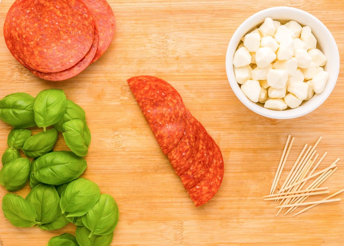 Folding a row of pepperoni in  half.